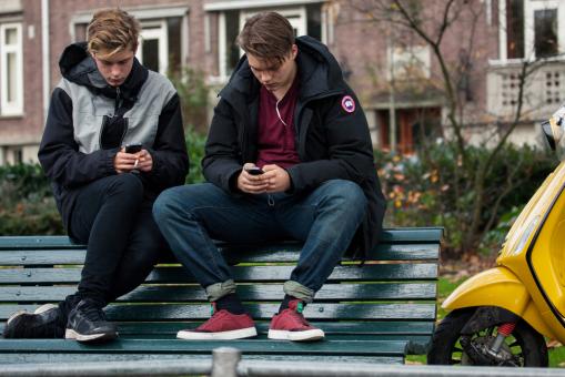 Two teenagers sit on a bench in Amsterdam, Netherlands. Birute Vijeikiene / Shutterstock.com Two teenagers sit on a bench in Amsterdam, Netherlands.