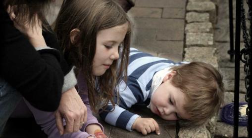 Children looking at a Monarch butterfly